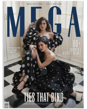 MEGA magazine cover with two women in black polka-dot gowns posing together; large blue MEGA title behind them.
